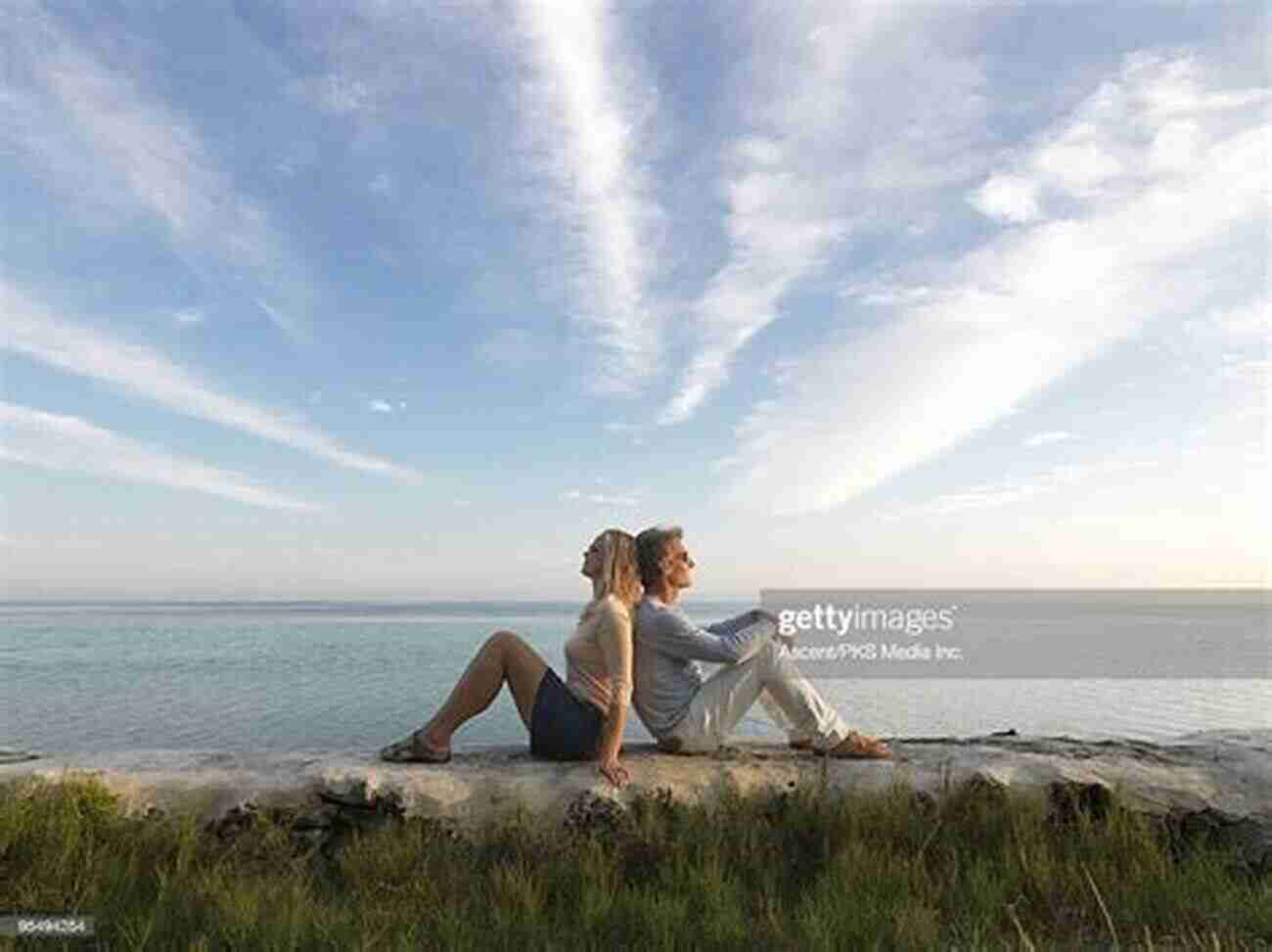 Couple Sitting On A Beach, Facing Opposite Directions With Saddened Expressions. Bad Tourist: Misadventures In Love And Travel